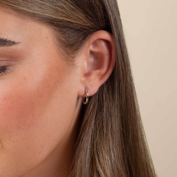 Model Wears Blair Large Plain Round Hoop Earrings White Gold Cropped