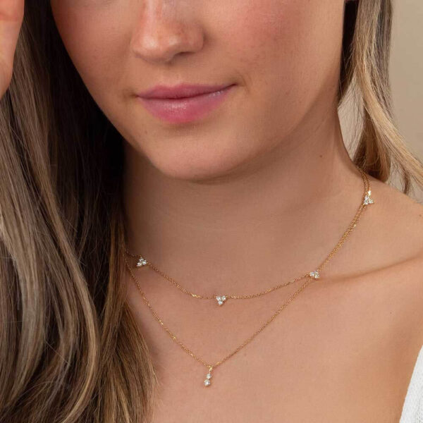 Model Wears Lab Grown Diamond Dew White Round Charm Layered Ivy 3 Stone Round Cluster Necklace Yellow Gold Cropped