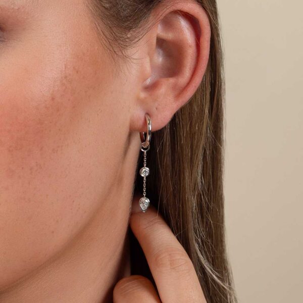 Model Wears Lab Grown Diamond Joanna Pear Bezel Two Stone Drop Earring Enhancer With Blair Large White Gold Hoops Cropped