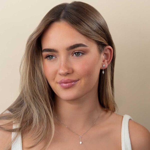 Model Wears White Gold Jen Pear Bezel Drop Enhancer With Athena Pear Diamond Earrings