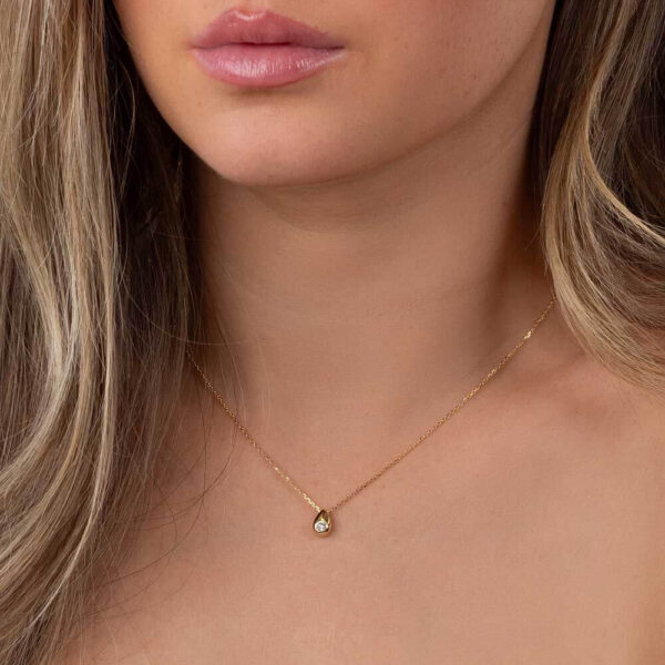 Model Wears Yellow Gold Bree Hammer Set Diamond Pear Shape Pendant Cropped