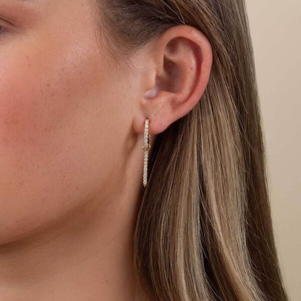 Model Wears Yellow Gold Gemma Large Pointed Bar Earring Enhancer With Erica 1.8 Large Prong Set Hoops Diamond Cropped