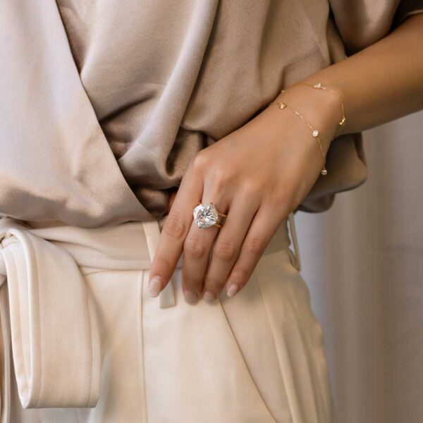 Model Wears Cassandra East West Set Cushion Moissanite Double Band Yellow Gold Ring