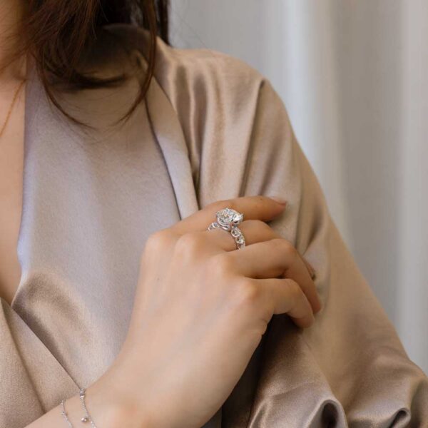 Model Wears Maxwell Moissanite Round Under Rail Graduating Scallop Prong Set Band White Gold Ring